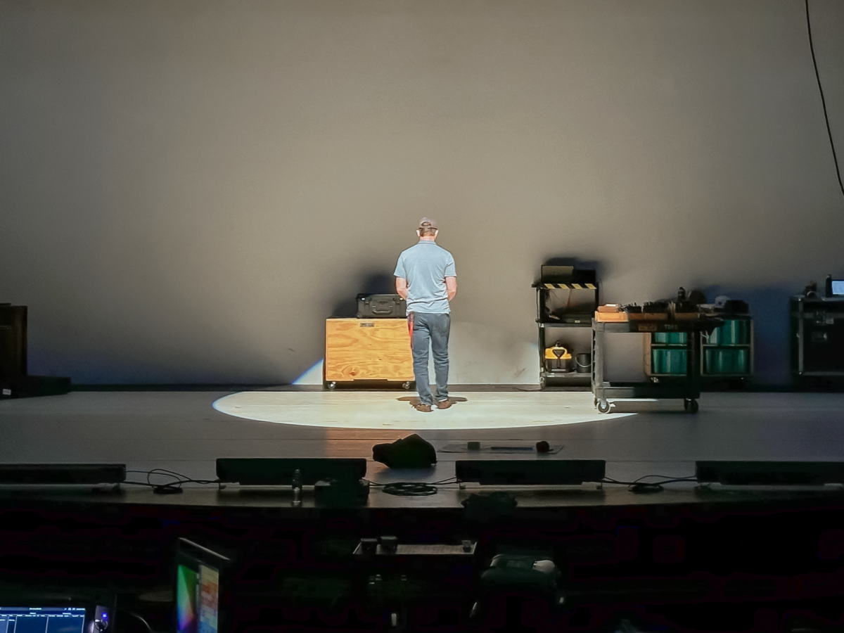 Professor Justin Thomas tests out lighting equipment as Roberts Theater prepares for the semester’s Dance Mainstage.