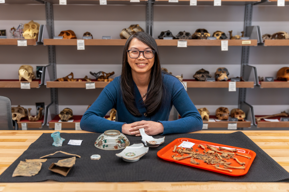 Assistant Professor of Anthropology Laura Ng poses for a portrait with Chinatown artifacts found at the Rock Springs, Wyo. dig site.