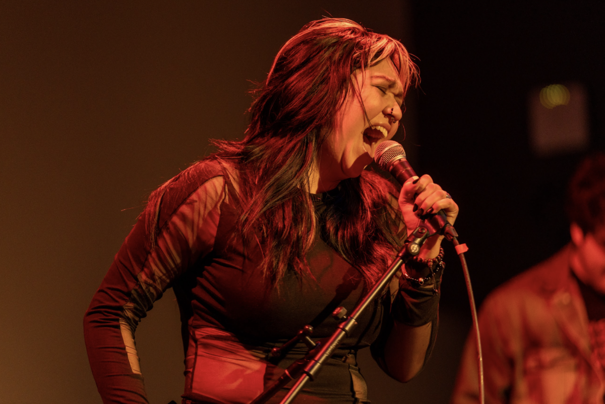 Marie Reyes-Alvarez `26, lead vocalist of punk rock band Partial Marxist, sings scream-filled "Bruise Violet" by Babes in Toyland for round one of Battle of the Bands.
