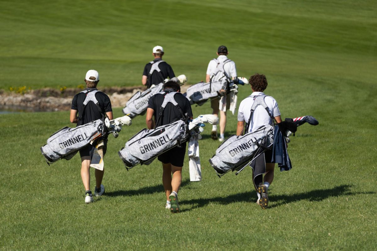 The men's golf team walks to the first fairway at the Grinnell College Golf Course during practice on Wednesday, April 22. 